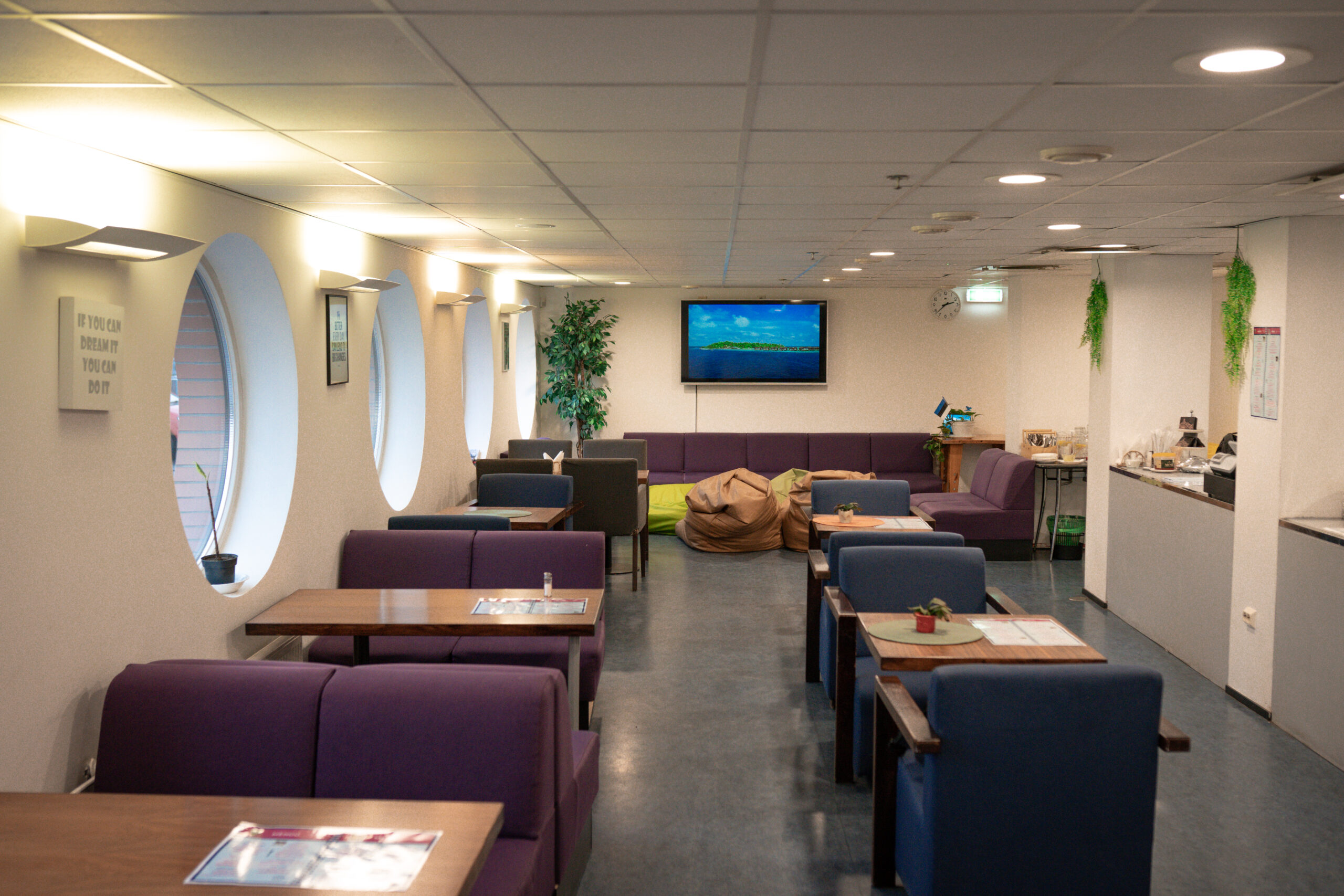 Herne Kohviku sisekujundus valgete seinte ja taimede dekoratsiooniga